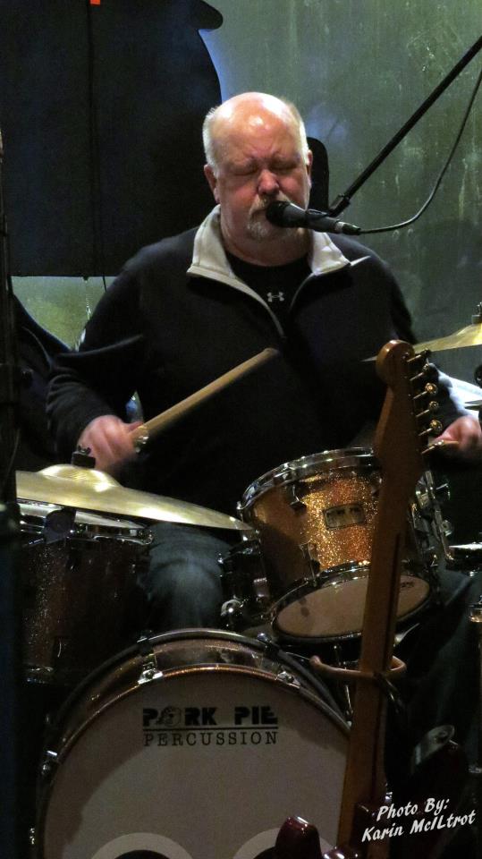 Bill singing and playing the drums